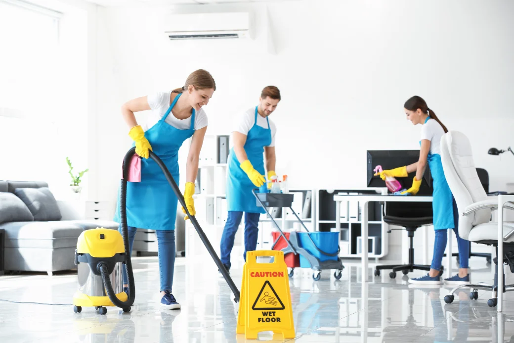 Three ODReight cleaners in aprons and gloves deep cleaning a room